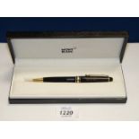 A cased Montblanc Meisterstuck ballpoint pen, with gold coloured trim and inscription.