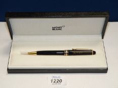 A cased Montblanc Meisterstuck ballpoint pen, with gold coloured trim and inscription.