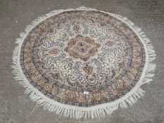 A blue and brown circular fringed rug, Indian design, approx.