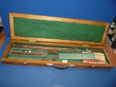 A Gun cleaning kit in a wooden case.