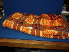 A Welsh wool double Blanket in orange, yellow and black colourway.