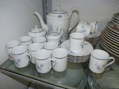 A Limoges personalised coffee service for twelve with blue blossoms on a white ground with silver