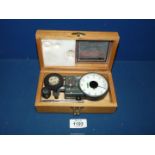 A vintage Lucas ATH4 Tachometer speed indicator in fitted wooden box with attachments.