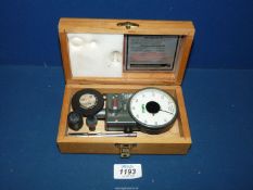 A vintage Lucas ATH4 Tachometer speed indicator in fitted wooden box with attachments.