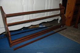 A mid Oak wall hanging plate rack having shaped ends (one strut requires re-attachment),