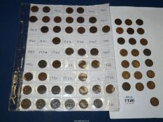 A quantity of mixed farthings dating from 1905-1965, some loose and some in a collectors sleeve.