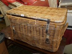 A vintage Cane Laundry Basket having leather fastening strap and two cane carrying handles,