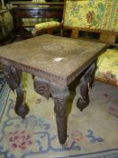 An Eastern hardwood design square Occasional Table standing on elephant head legs,