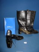 A pair of Marks & Spencer knee high boots in black with side zip and buckle,