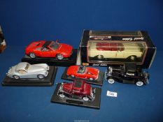 Six large scale model cars including Burago Jaguar XK120, Ferrari, etc.