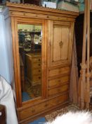 An Ash wood wardrobe having black detailing and with hanging cupboard,