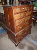 A Georgian Chest on Chest having five long and three short Walnut fronted drawers with cross