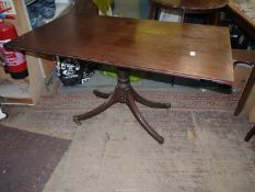 A period snap top table having a turned pillar with four swept feet terminating in brass capped