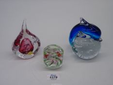 Three paperweights including an Adam Jablonski heavy teardrop glass paperweight with ruby red
