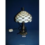 A Tiffany style table lamp with a cream jeweled glass shade, 13'' tall.