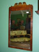 A Georgian Walnut fretworked framed wall hanging mirror, possibly with later glass,