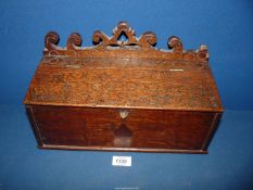 An Oak Candle Box with diamond pattern to front, fretwork scrollwork to upstand,