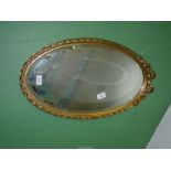 A pretty bevelled edge wall Mirror with gilt frame decorated with bow, roses and twisted design,