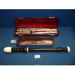 A cased Yamaha Flute and a cased Aulos recorder.