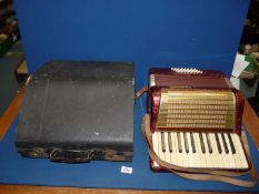 A cased Worldmaster accordion.