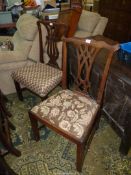 Two Georgian Mahogany framed side Chairs having fretworked splats and standing on square legs,