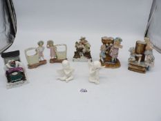 A quantity of china ornaments including two cherubs, boy and girl with baskets,