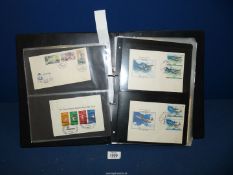 A black Folder, an eclectic mix of worldwide circa 1950's First Day Covers,