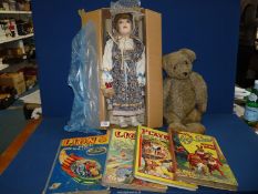 An old German made jointed Teddy Bear with glass eyes and pad feet, boxed doll with porcelain head,
