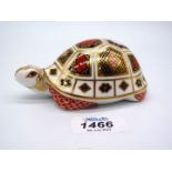 A Royal Crown Derby Tortoise paperweight with gold stopper.