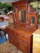 A 1920/30's Satinwood mirrorback Sideboard having a pair of opposing doors with a pair of frieze