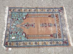 A Persian Prayer Rug in pink and turquoise, some wear, 25 1/2'' wide x 36'' long.