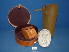 A circular leather collar box and a smaller leather case within,