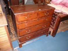 A 19th century Oak chest of three long and two short drawers having Yew wood cross-banding
