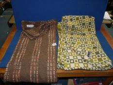 Two Melin Tregwynt single blankets, one 'lambswool' (brown) and the other 'pure new wool' (green).
