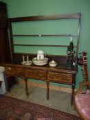 An early 19th century Oak Welsh dresser standing on six turned legs and having three deep drawers