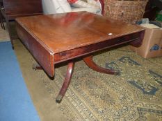 A 19th century Mahogany rectangular Dining/Centre Table having barrow drop leaves and riased on a