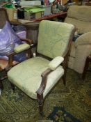 A circa 1900 Mahogany framed open armed elbow Chair having tapering turned and fluted front legs,