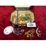 A small jewellery box and contents including Celtic style brooch, polished stone, earrings,