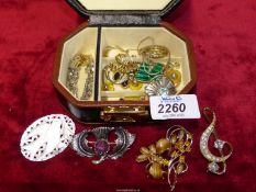 A small jewellery box and contents including Celtic style brooch, polished stone, earrings,