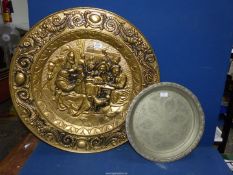 A large brass charger depicting pub scene, 20 1/2" diameter and a metal engraved tray, 16" diameter.