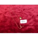 A 9ct gold chain (0.8g) and a locket (1.3g) stamped '9ct gold back and front'.
