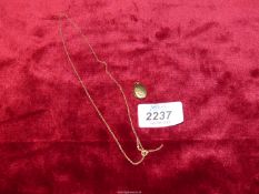 A 9ct gold chain (0.8g) and a locket (1.3g) stamped '9ct gold back and front'.