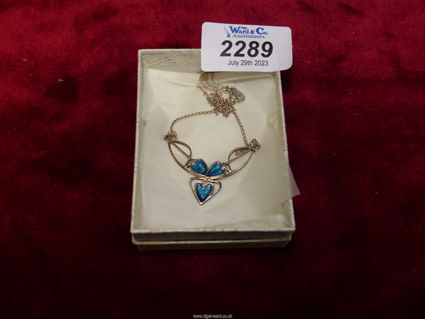 A John McKellar pendant and chain of 925 silver with blue heart shaped enamel detail.