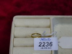 A 22ct gold wedding band, size I, 0.8g.