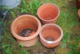 Three terracotta flower pots.
