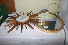 An Oval mirror and Wall clock.