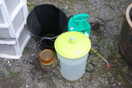 A knapsack sprayer plus a coal bucket, and a stone jar.