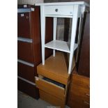 A small white table with a drawer, plus a two drawer office cabinet.