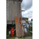 A thirteen rung wooden extension ladder.