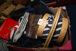 A box of handbags and boaters.